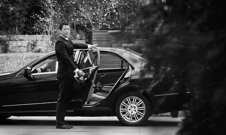 Chauffeur holding a car door open