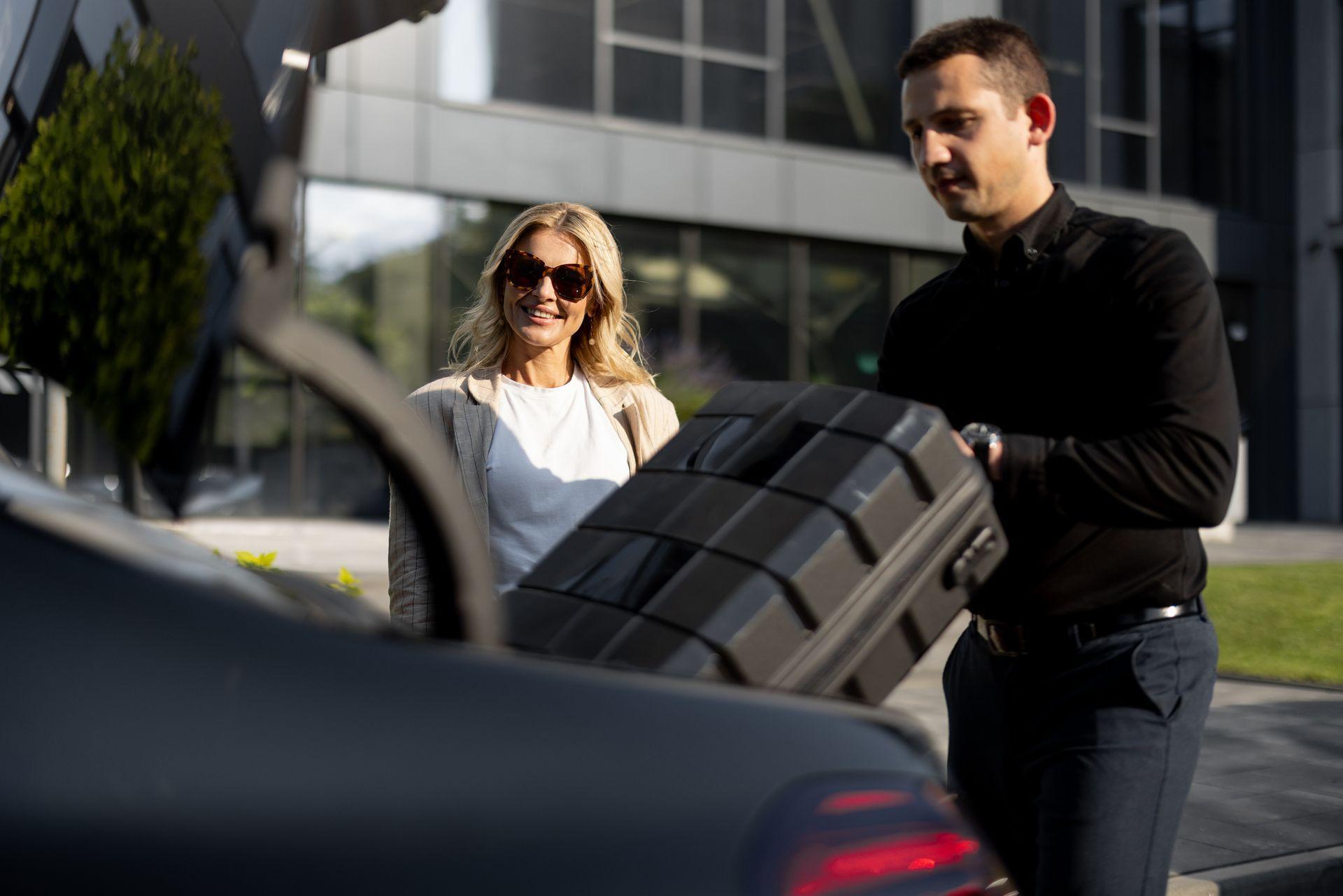 Chauffeur loading luggage for a client