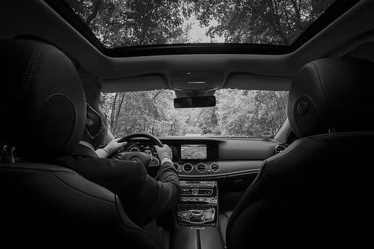 Chauffeur driving, seen from the back seat